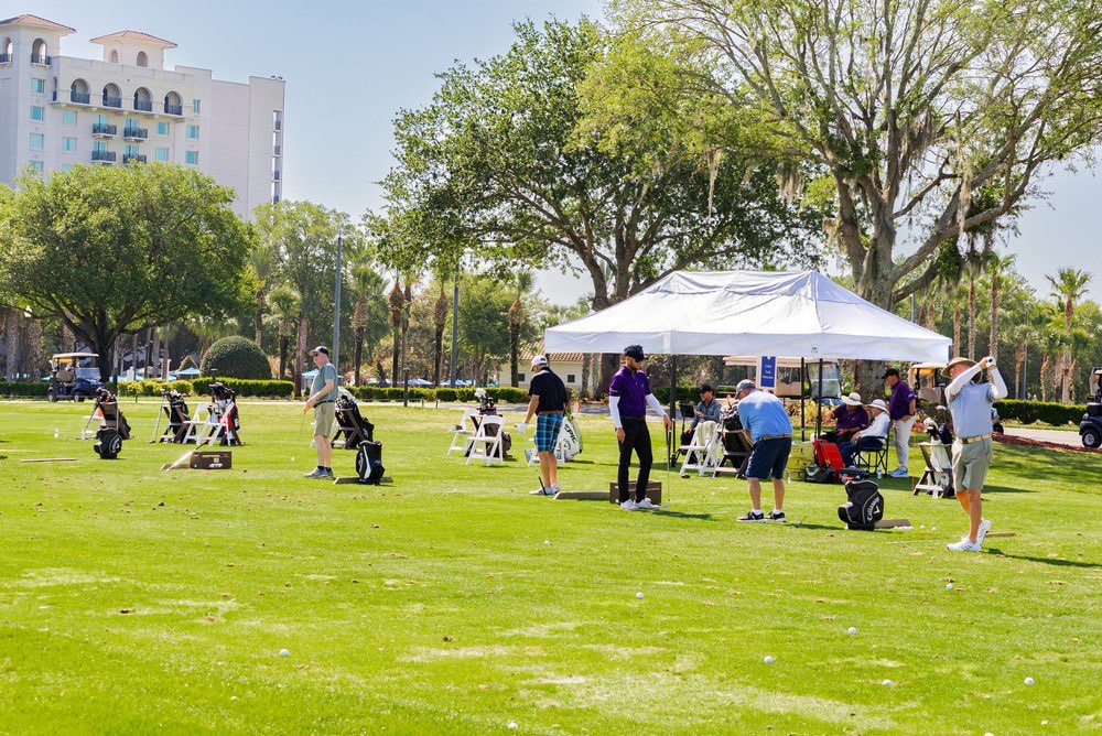 A small group of golfers on the range at ChampionsGate with an Instant Golf Improvement coach